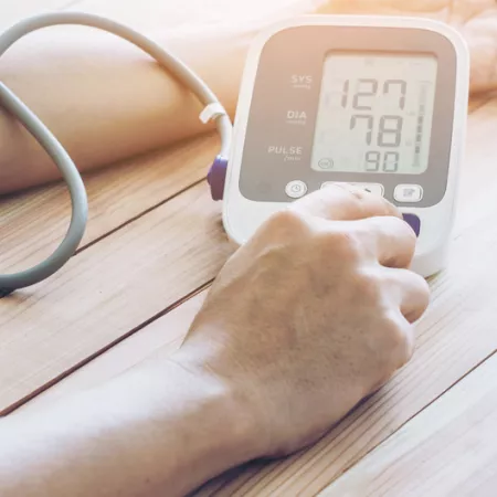 a person using an at home bp monitor