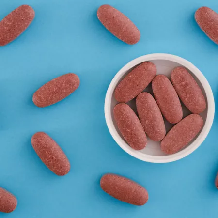 Red yeast rice tablets on a blue background