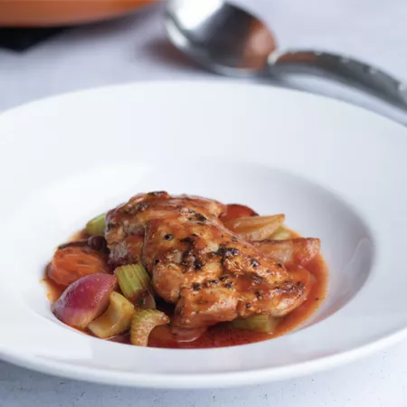 large white bowl with chicken a sauce