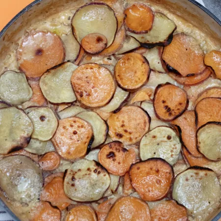 pan filled with scalloped potatoes in a sauce
