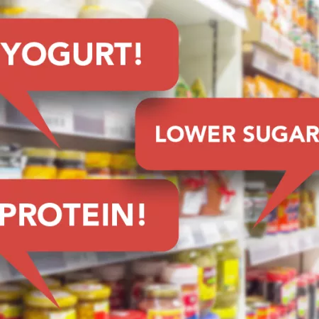 grocery store shelves with red speech bubbles reading "yogurt, lower sugar"protein, lower