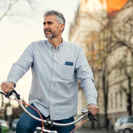 man on a bike riding through a city