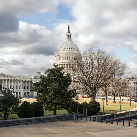 View of the Capitol Building against a cloudy sky from across the street