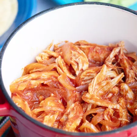 red pot full of pulled chicken 
