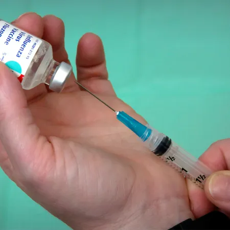 Flu vaccine being extracted from a vial