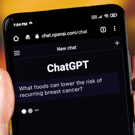 hand holding smart phone that says "ChatGPT" on screen