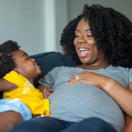 a pregnant mother and her daughter