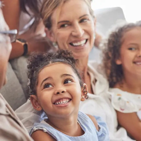 3 generations of women smiling at each other