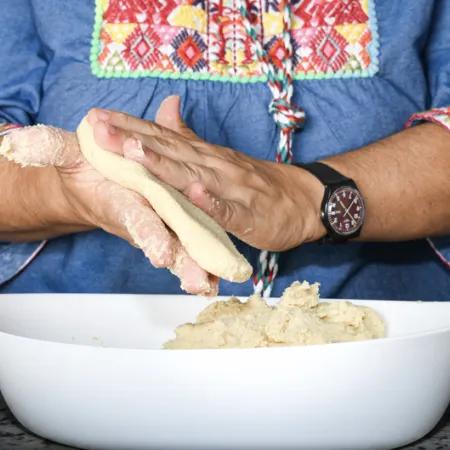 woman's hands making a corn flour tortilla