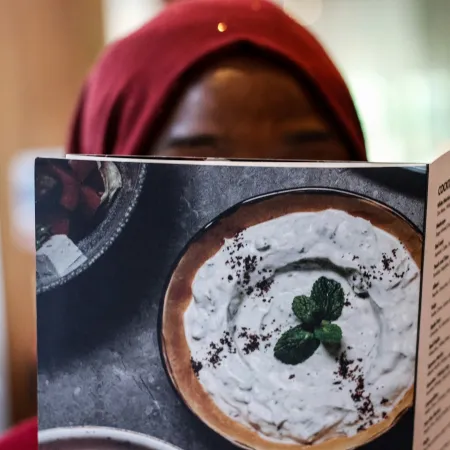 A woman reading a menu.