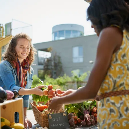 women buying and selling at a farmer's market