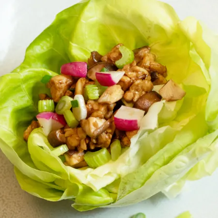 lettuce cup filled with various vegetables and tempeh